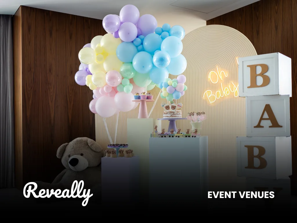 A pastel balloon-decorated Oh Baby celebration set up at an event venue